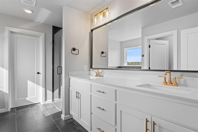 bathroom featuring vanity, a shower with door, and tile patterned flooring