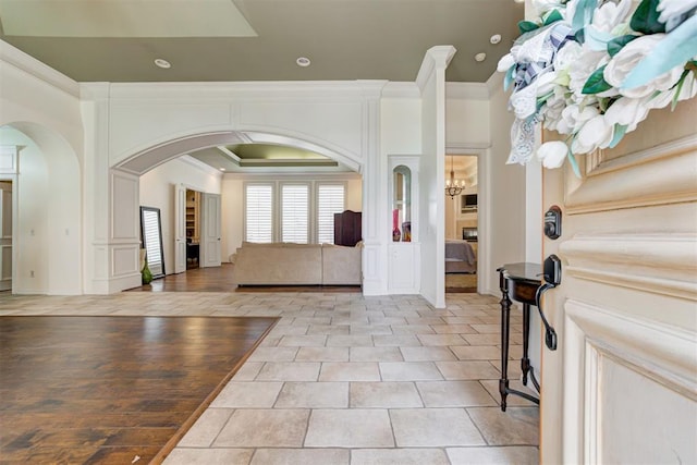 foyer entrance featuring light hardwood / wood-style floors and ornamental molding