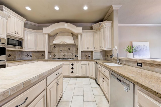 kitchen featuring light tile patterned floors, stainless steel appliances, crown molding, and sink