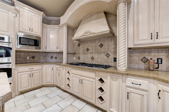 kitchen with custom range hood, backsplash, and stainless steel appliances