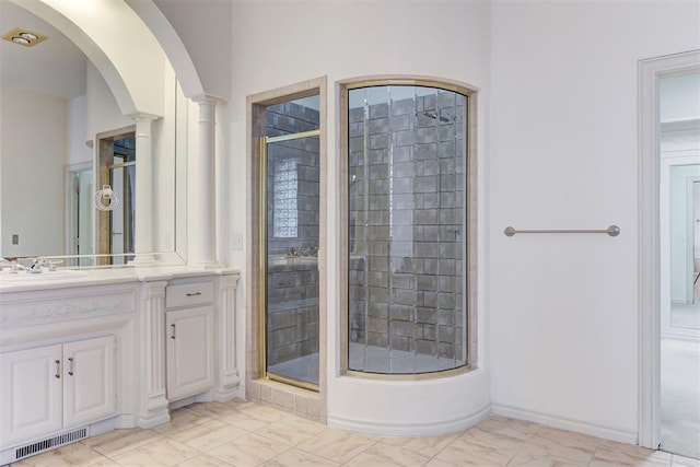 bathroom featuring vanity and a shower with shower door