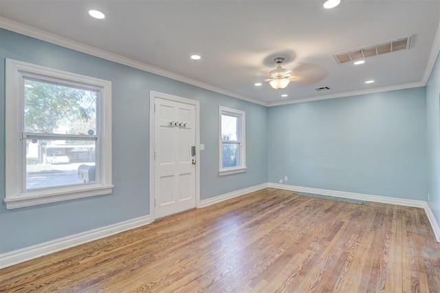 foyer entrance with ceiling fan, crown molding, and light hardwood / wood-style flooring