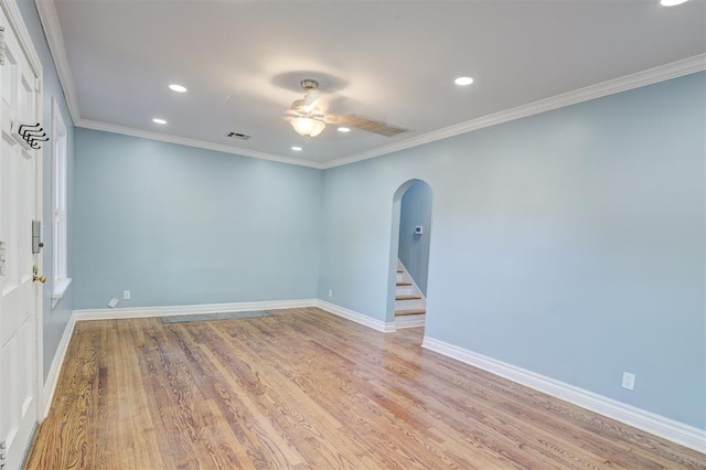 spare room featuring ceiling fan, light hardwood / wood-style floors, and ornamental molding