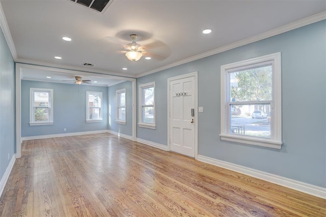 entrance foyer featuring ceiling fan, a healthy amount of sunlight, light hardwood / wood-style floors, and ornamental molding