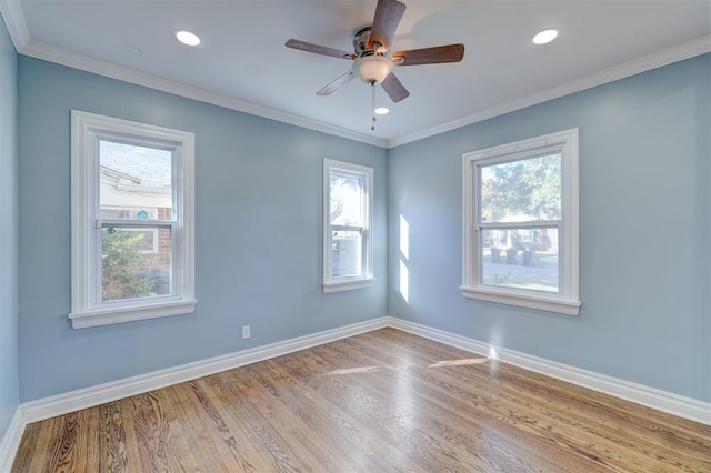 empty room with ceiling fan, ornamental molding, and light hardwood / wood-style flooring