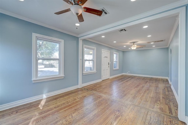 spare room with crown molding, ceiling fan, and light wood-type flooring