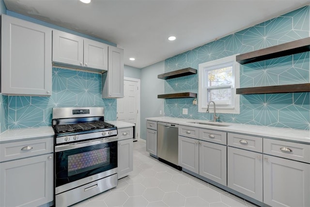 kitchen with decorative backsplash, light tile patterned floors, stainless steel appliances, and sink