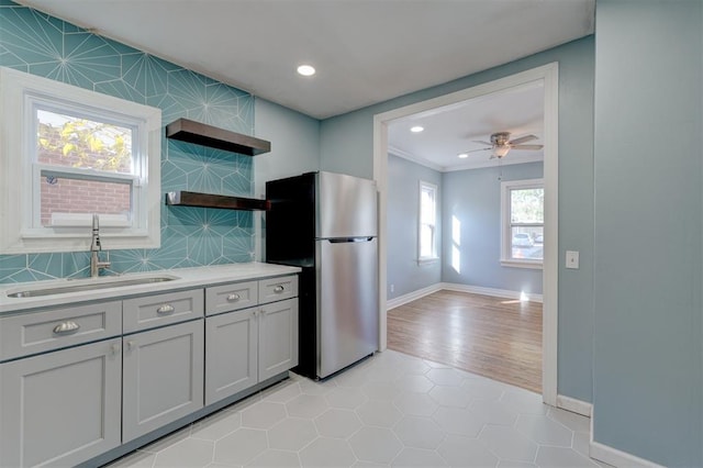 kitchen with plenty of natural light, stainless steel fridge, sink, and ceiling fan