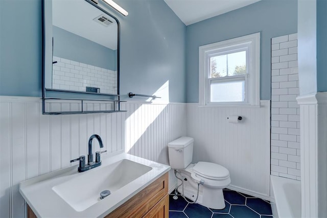 bathroom with tile patterned floors, vanity, and toilet