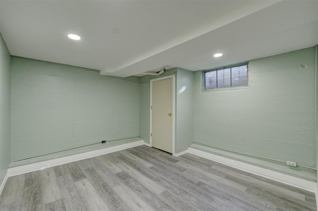 basement with light hardwood / wood-style floors