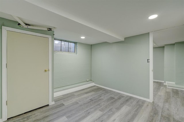 basement with light hardwood / wood-style flooring