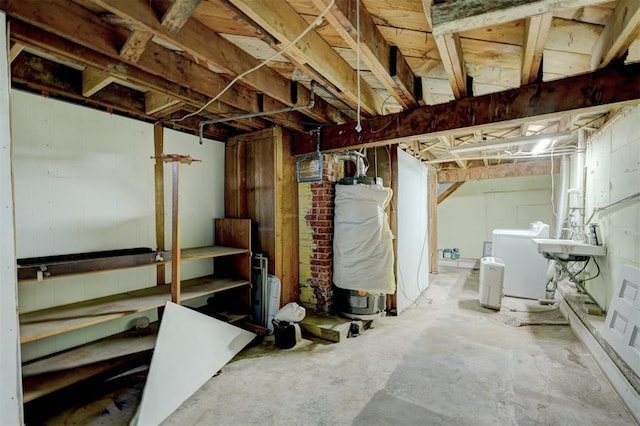 basement featuring washing machine and dryer and water heater