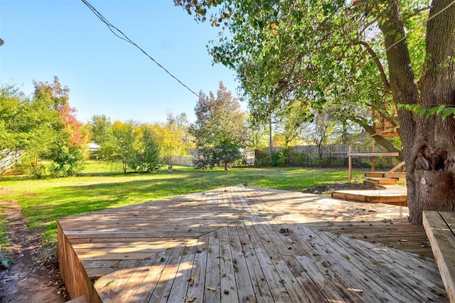 wooden terrace featuring a lawn