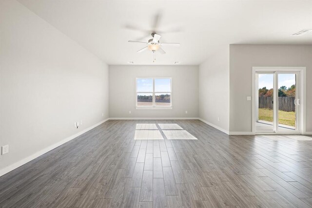 unfurnished room with a wealth of natural light and dark hardwood / wood-style floors