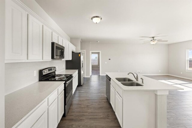 kitchen with sink, plenty of natural light, white cabinets, and appliances with stainless steel finishes