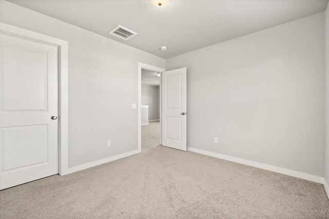 unfurnished bedroom with light colored carpet