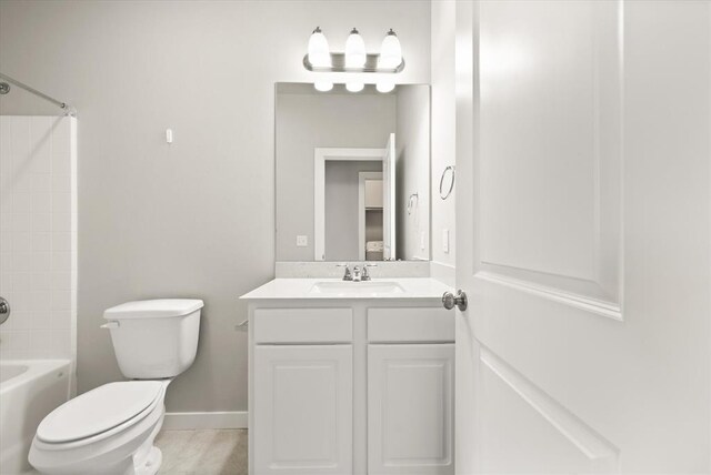 full bathroom featuring shower / bathing tub combination, vanity, and toilet