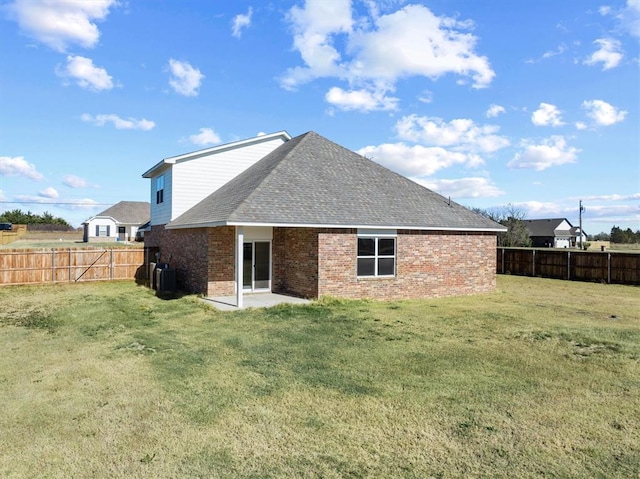 back of property featuring a yard, a patio area, and central air condition unit