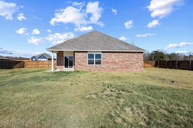 back of house featuring a yard