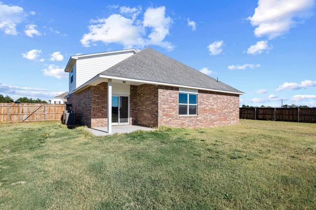 back of property with a yard, a patio, and central air condition unit