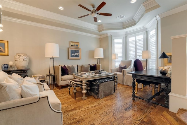 living room featuring ceiling fan, wood-type flooring, and crown molding