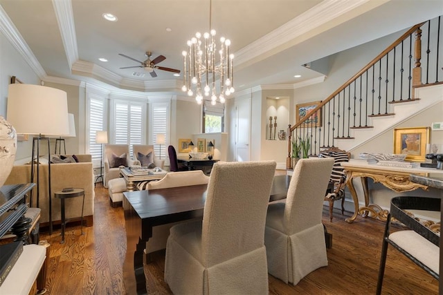 dining room with ceiling fan with notable chandelier, dark hardwood / wood-style floors, and crown molding