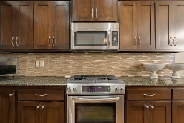 kitchen featuring backsplash, stainless steel appliances, and dark stone counters