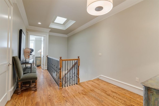 additional living space with a skylight and light hardwood / wood-style floors