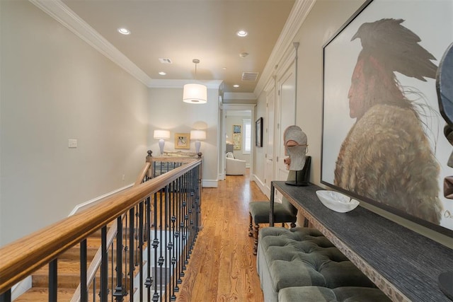 hall with crown molding and light wood-type flooring