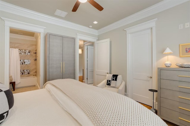 bedroom with connected bathroom, a closet, ceiling fan, and ornamental molding