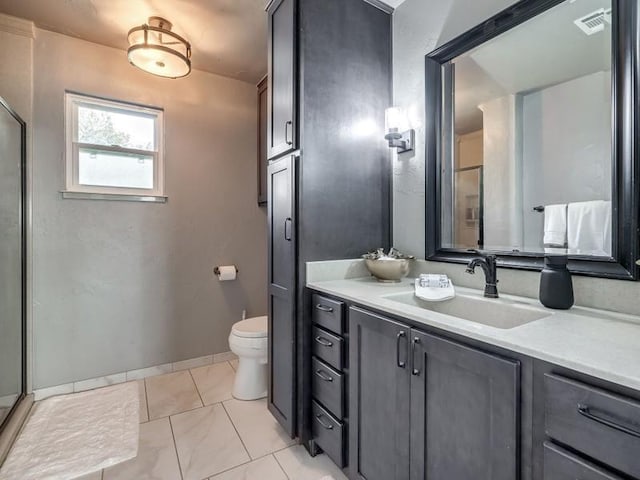 bathroom with tile patterned floors, vanity, toilet, and an enclosed shower