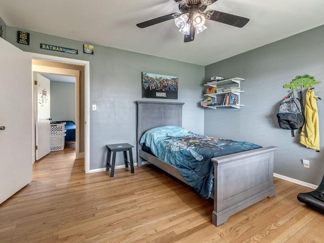 bedroom with light hardwood / wood-style flooring and ceiling fan