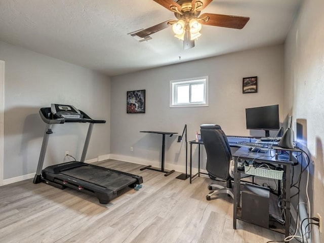 home office with ceiling fan and light hardwood / wood-style flooring