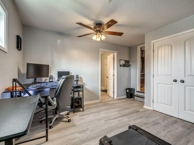 office space featuring light hardwood / wood-style flooring and ceiling fan