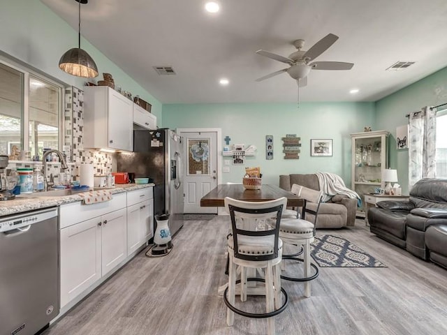 interior space featuring sink, light hardwood / wood-style flooring, a wealth of natural light, and ceiling fan