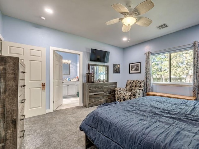 carpeted bedroom featuring ensuite bathroom and ceiling fan