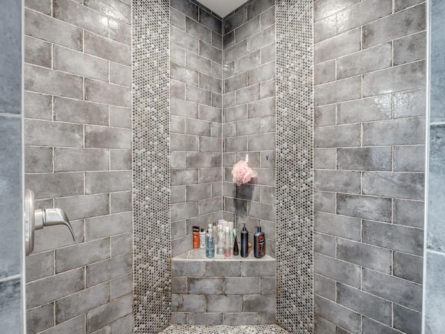 bathroom with tiled shower