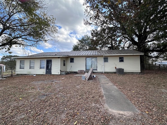 rear view of house featuring central AC unit