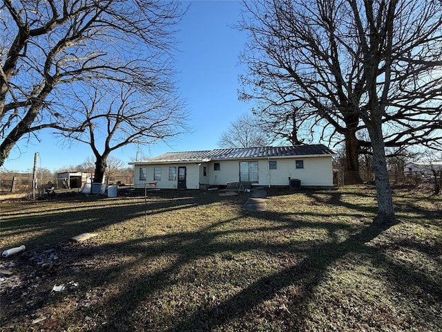 rear view of property featuring a yard