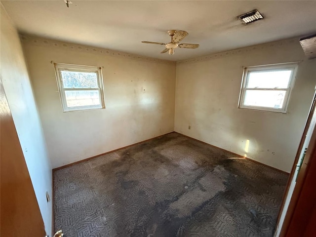 empty room featuring carpet floors and ceiling fan