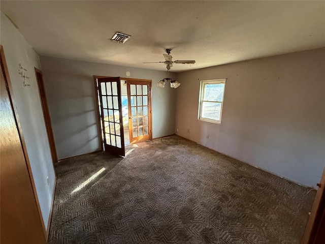 carpeted empty room with ceiling fan and french doors