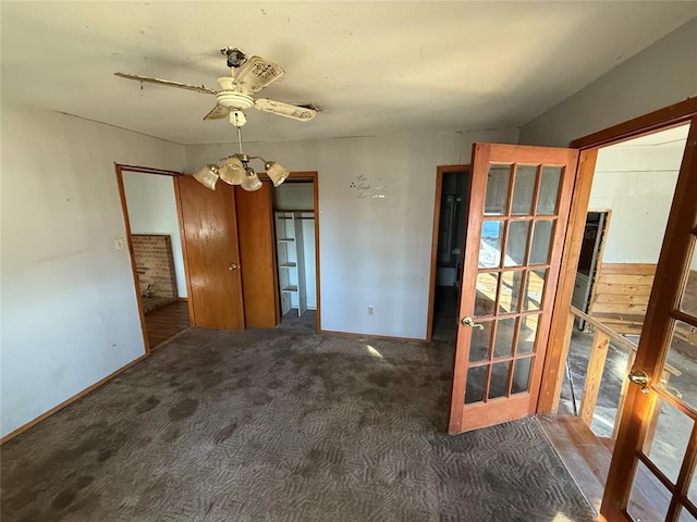 carpeted spare room with ceiling fan and french doors