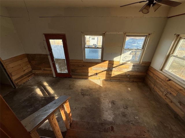 spare room featuring wooden walls and ceiling fan