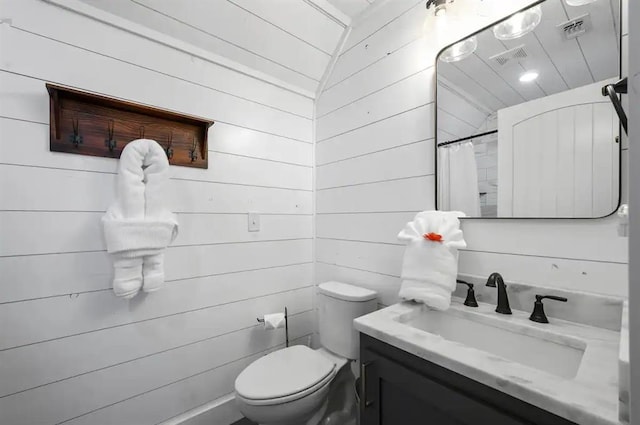 bathroom with a shower with shower curtain, vanity, wooden walls, toilet, and lofted ceiling