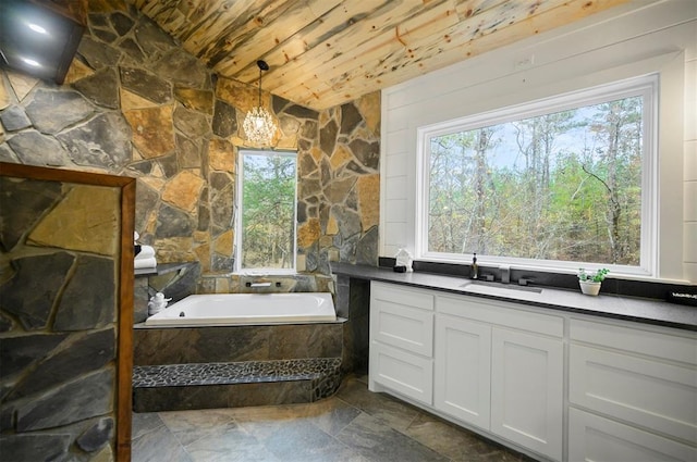 bathroom featuring vanity, a wealth of natural light, wooden ceiling, and tiled tub