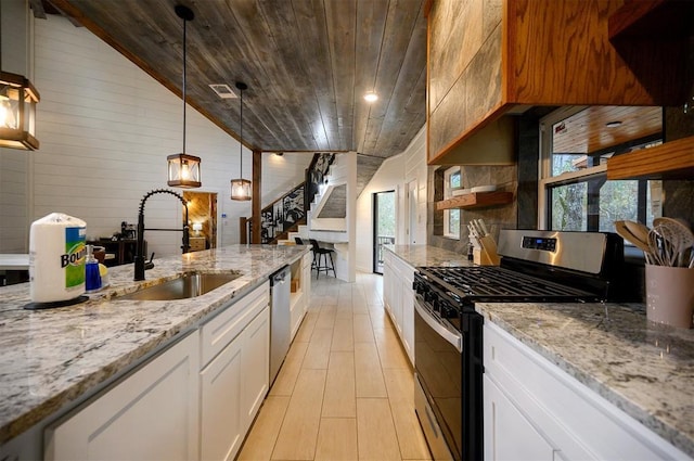 kitchen with white cabinets, lofted ceiling, sink, and appliances with stainless steel finishes