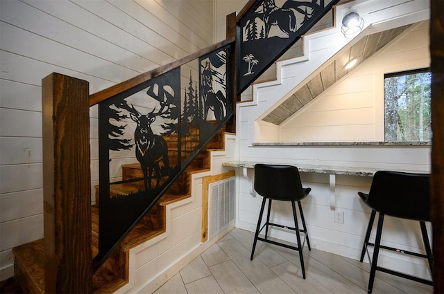 staircase with wooden walls