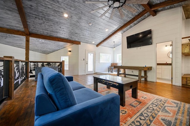 living room with lofted ceiling with beams, a wealth of natural light, and dark wood-type flooring