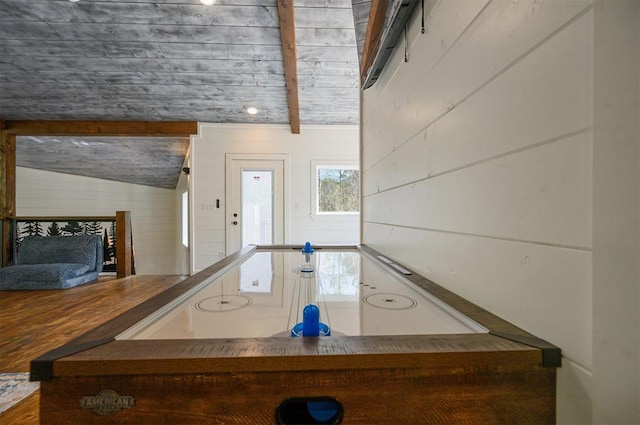 interior space featuring lofted ceiling and wooden walls