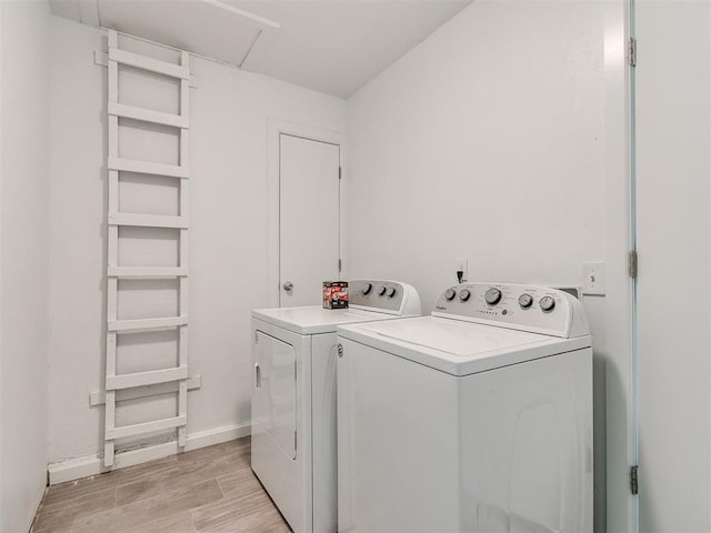 laundry area with light wood-type flooring and independent washer and dryer